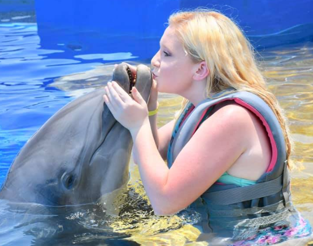 lady kissing dolphin